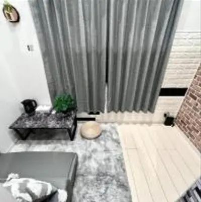 a living room with a gray curtain and a couch at \u3072\u3060\u307e\u308a One in Tokyo