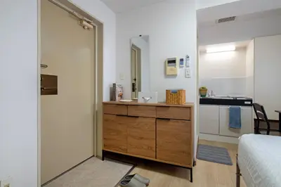 a bedroom with a bathroom with a sink and a mirror at CraftFlat Komagome Family 6 in Tokyo