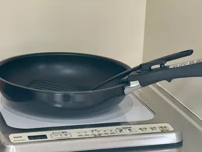 a black pan sitting on top of a stove at \u3059\u304c\u3082\u5c0f\u5bbf in Tokyo
