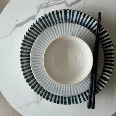 a plate sitting on a table with chop sticks at \u3059\u304c\u3082\u5c0f\u5bbf in Tokyo