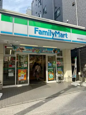 a familymart store with a sign on the front of it at \u3059\u304c\u3082\u5c0f\u5bbf in Tokyo