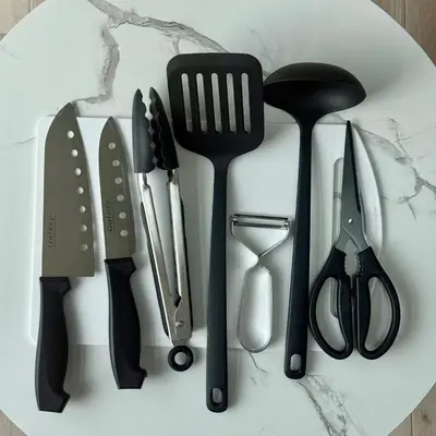 a bunch of kitchen utensils are arranged on a counter at \u3059\u304c\u3082\u5c0f\u5bbf in Tokyo