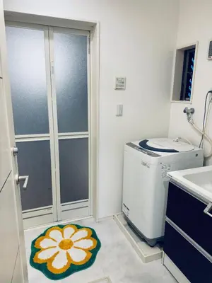 a small bathroom with a washing machine and a rug at Ikebukuro\u6c60\u888b1stop-2min-Kitaikebukuro\u5317\u6c60\u888bwalk3min in Tokyo