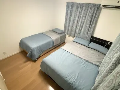 a bedroom with two beds and a window at Ikebukuro\u6c60\u888b1stop-2min-Kitaikebukuro\u5317\u6c60\u888bwalk3min in Tokyo
