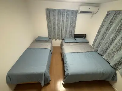 two beds in a small room with curtains at Ikebukuro\u6c60\u888b1stop-2min-Kitaikebukuro\u5317\u6c60\u888bwalk3min in Tokyo