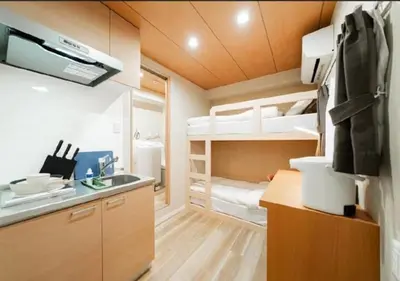 a small kitchen with a sink and bunk beds at Oshiage SAIEI Hotel 101 in Tokyo