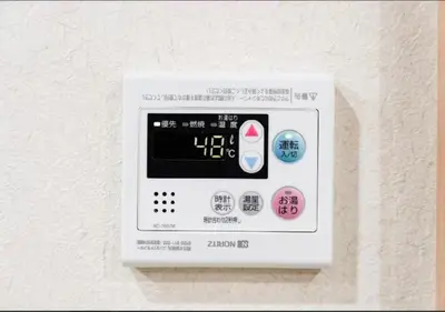 an electronic thermostat on a white wall at Oshiage SAIEI Hotel 101 in Tokyo