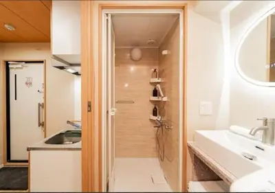 a small bathroom with a sink and a shower at Oshiage SAIEI Hotel 101 in Tokyo