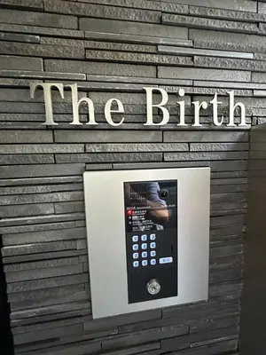 a remote control in front of a sign on a wall at The Birth 501 in Tokyo