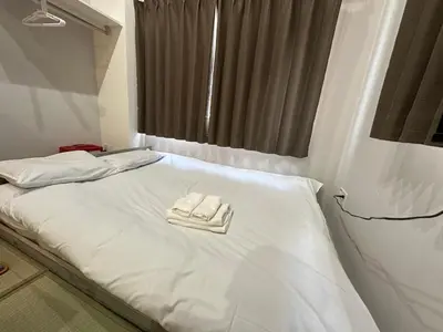 a hospital bed with two white towels on it at The Birth 501 in Tokyo