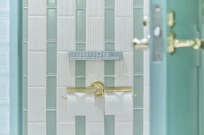 a close up of a door with a sign on it at Q-ROOMS Harajuku in Tokyo