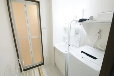 a white bathroom with a shower and a sink at Grazia\u5c0f\u5ca9 201 in Tokyo