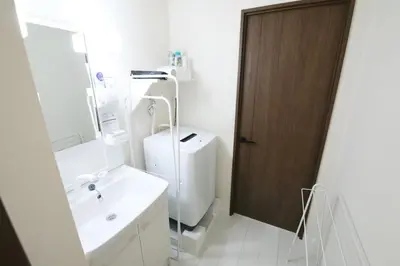 a bathroom with a sink and a toilet and a mirror at Grazia\u5c0f\u5ca9 201 in Tokyo