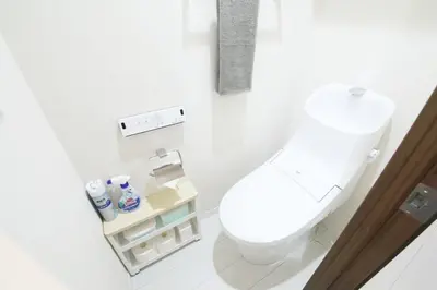 a white bathroom with a toilet and a sink at Grazia\u5c0f\u5ca9 201 in Tokyo
