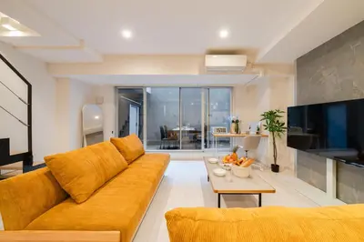 a living room with a couch and a table at \u5143\u9ebb\u5e03\u30ec\u30b8\u30c7\u30f3\u30b9106 Sakura in Tokyo