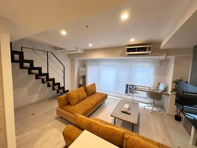 a living room with a couch and a piano at \u5143\u9ebb\u5e03\u30ec\u30b8\u30c7\u30f3\u30b9106 Sakura in Tokyo
