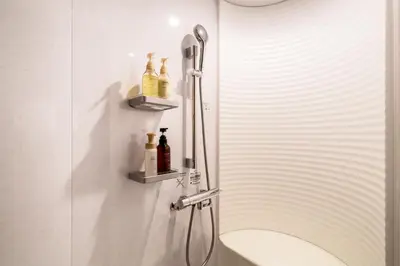 a bathroom with a shower with a sink at Gold HOTEL SHIBUYA in Tokyo