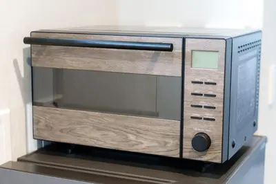 a microwave oven sitting on top of a shelf at Gold HOTEL SHIBUYA in Tokyo