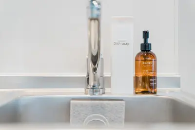 a bottle of alcohol sitting on a kitchen sink at Gold HOTEL SHIBUYA in Tokyo