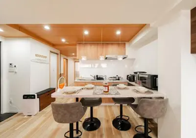 a kitchen with a large island with bar stools at Oshiage SAIEI Hotel 201 in Tokyo