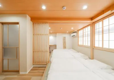 a row of beds in a room with a window at Oshiage SAIEI Hotel 201 in Tokyo