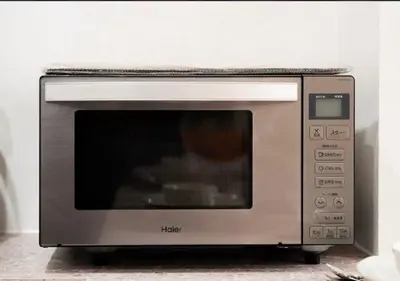 a silver microwave oven sitting on top of a counter at Oshiage SAIEI Hotel 201 in Tokyo