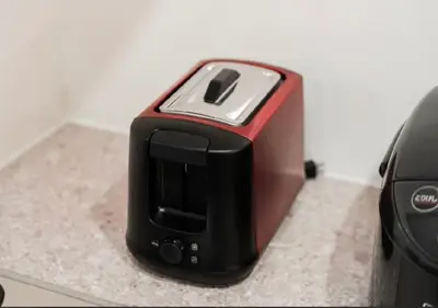 a black and red toaster sitting on a counter at Oshiage SAIEI Hotel 201 in Tokyo