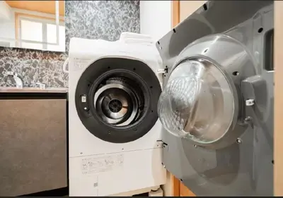 a washing machine is sitting in a kitchen at Oshiage SAIEI Hotel 201 in Tokyo