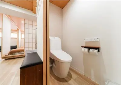 a bathroom with a white toilet and a mirror at Oshiage SAIEI Hotel 201 in Tokyo