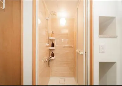 a bathroom with a shower with a glass door at Oshiage SAIEI Hotel 201 in Tokyo