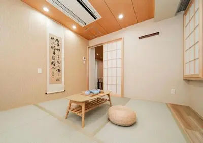 a living room with a table and a stool at Oshiage SAIEI Hotel 301 in Tokyo