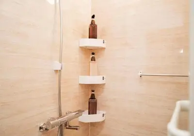 a bathroom with three bottles on a wall at Oshiage SAIEI Hotel 301 in Tokyo