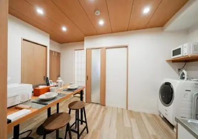 a kitchen with a table and chairs in a room at Oshiage SAIEI Hotel 301 in Tokyo