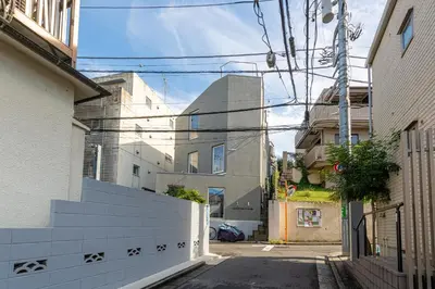 an alley with some buildings and a fence at Ouverture102 Yoyogi Koen Station 10minute in Tokyo