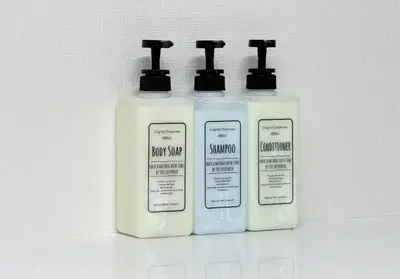 three bottles of shampoo and conditioner on a shelf at Ouverture102 Yoyogi Koen Station 10minute in Tokyo