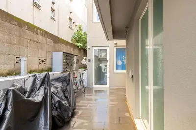 a hallway of a house with tiled floors and a glass door at Ouverture102 Yoyogi Koen Station 10minute in Tokyo