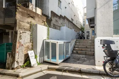 a gate on the side of a building with stairs at Ouverture102 Yoyogi Koen Station 10minute in Tokyo