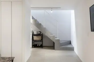 a staircase in a house with white walls at Ouverture102 Yoyogi Koen Station 10minute in Tokyo