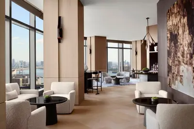 a lobby with white chairs and tables and windows at JW Marriott Hotel Tokyo in Tokyo
