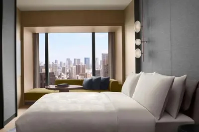 a bedroom with a large white bed and a large window at JW Marriott Hotel Tokyo in Tokyo