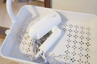 a white electric hair dryer in a plastic container at Yoyogi Flats - Vacation STAY 19767 in Tokyo