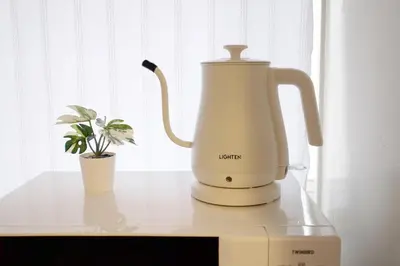 a white electric kettle and a plant on a counter at Yoyogi Flats - Vacation STAY 19767 in Tokyo