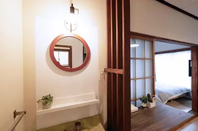 a bathroom with a mirror and a sink in a room at Yoyogi Flats - Vacation STAY 19767 in Tokyo