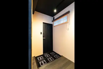 a door leading into a room with a rug at Koala Inn Ueno in Tokyo