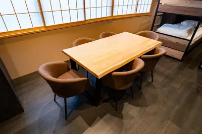 a wooden table and chairs in a room at Koala Inn Ueno in Tokyo