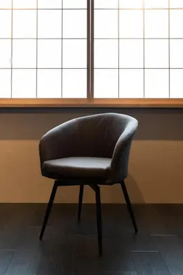 a chair sitting in front of a window at Koala Inn Ueno in Tokyo