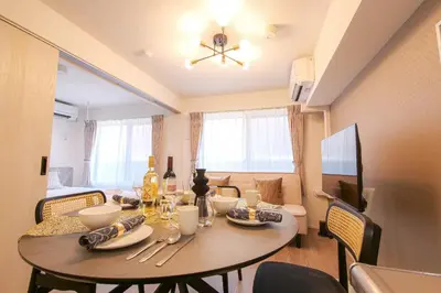 a dining room with a table and chairs and a room with at JAPAN APARTMENT HOTEL Itabashi-station, Tokyo in Tokyo