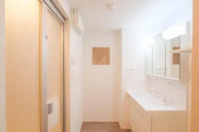 a white bathroom with a sink and a mirror at JAPAN APARTMENT HOTEL Itabashi-station, Tokyo in Tokyo