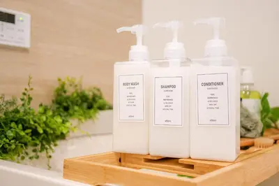 three bottles of soap on a shelf in a bathroom at JAPAN APARTMENT HOTEL Itabashi-station, Tokyo in Tokyo