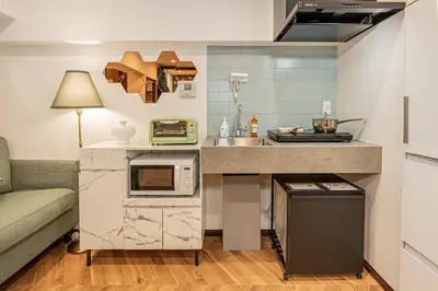 a small kitchen with a sink and a microwave at Within easy reach of Shinjuku bustling district 4 minutes walk from nearest station 2 room apartment with lift Suitable for families and groups in Tokyo